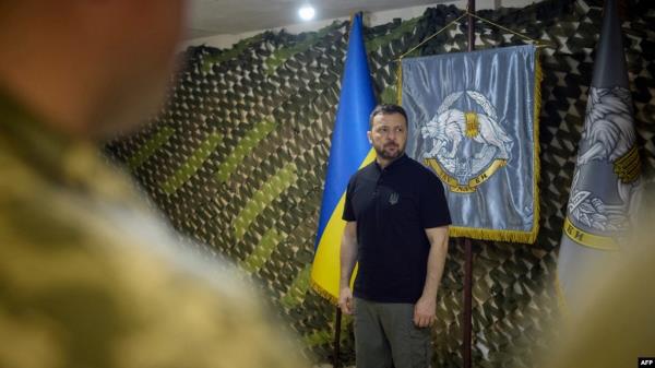 FILE - Ukrainian President Volodymyr Zelensky visiting the command outpost of the Special Operations Forces of the Armed Forces of Ukraine, in the area of Vovchansk, Kharkiv region, July 29, 2024. (AFP photo / Ukrainian Presidential Press Service) " 